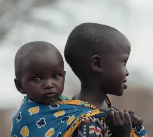 Sisterly Strength: A Young Girl Carrying Hope in Kenya