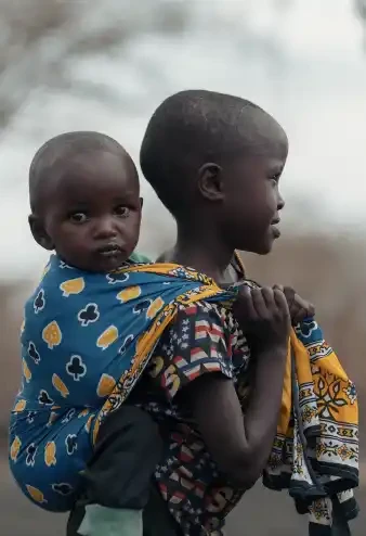Sisterly Strength: A Young Girl Carrying Hope in Kenya